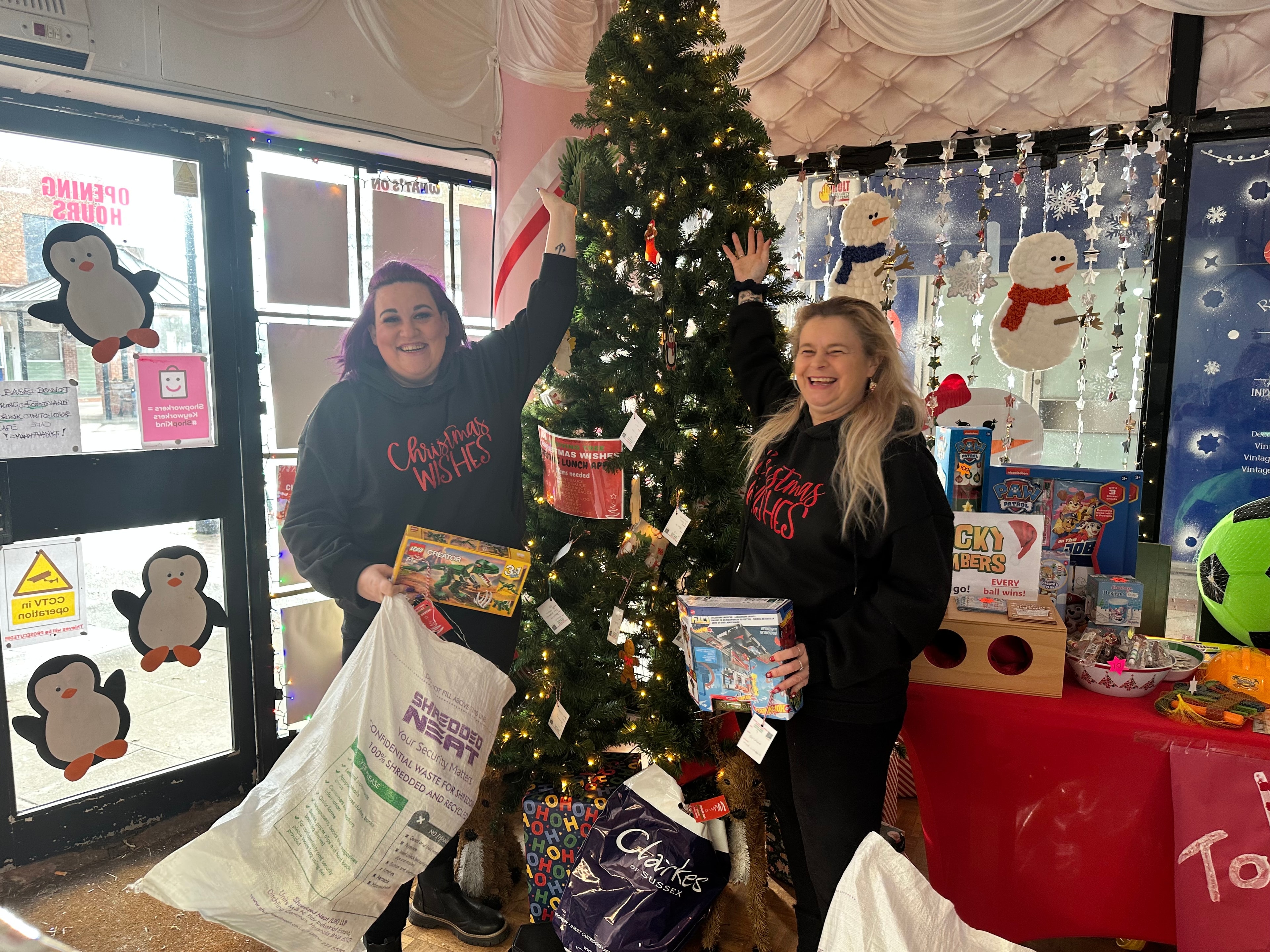 Elf Squad volunteers with a boot full of donated toys